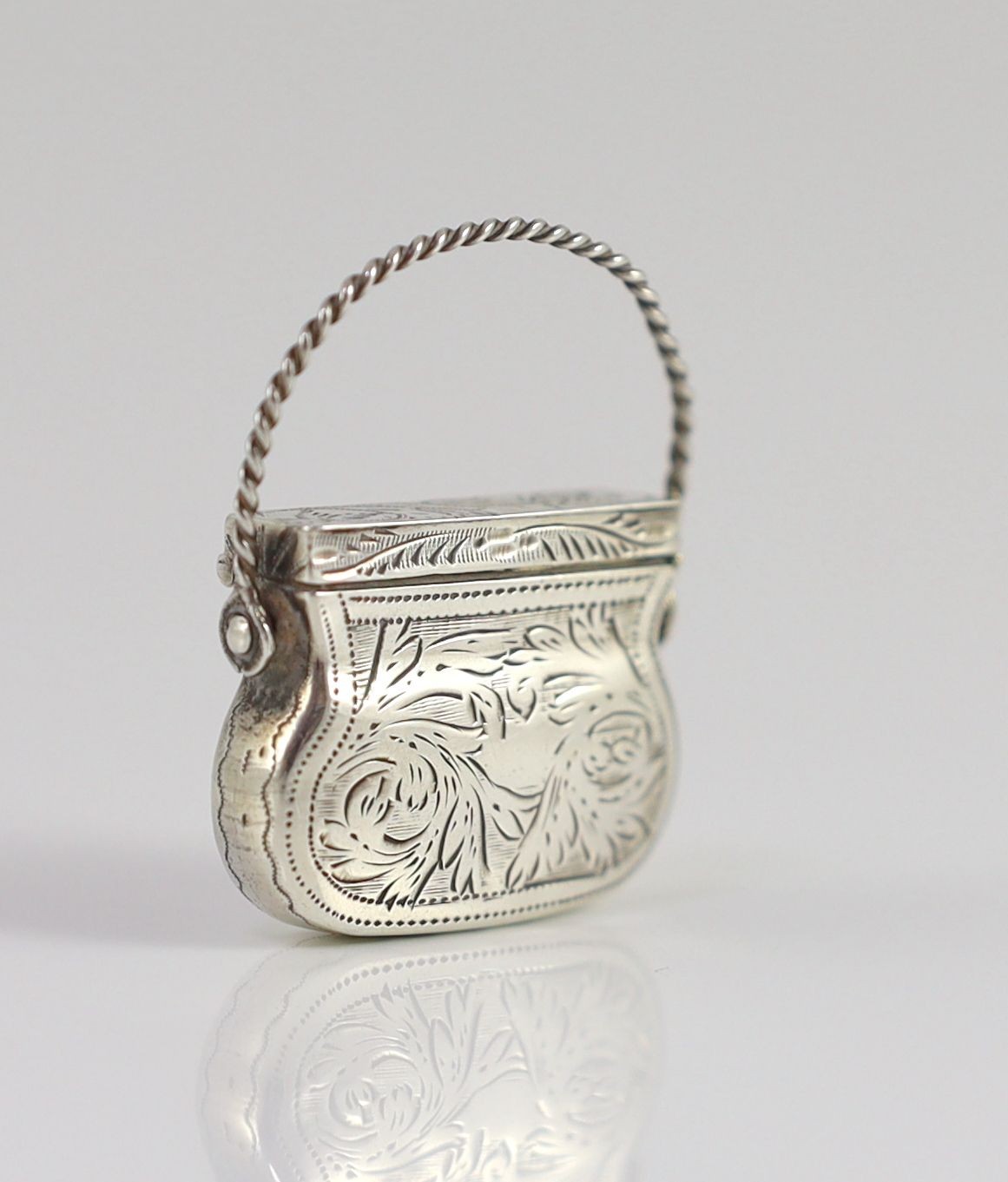 A George IV engraved silver vinaigrette, modelled as a handbag, by Gervase Wheeler